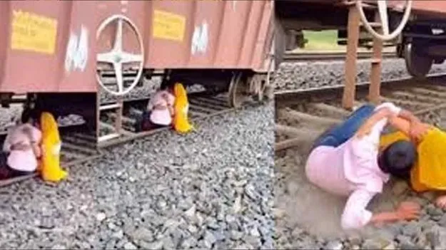 Couple Romances: రైలు కింద ప్రేమ జంట రొమాన్స్.. తృటిలో తప్పిన ప్రమాదం