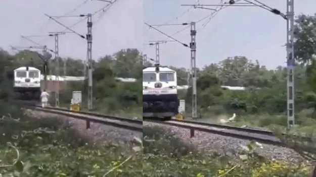 వేగంగా వస్తున్న రైలు ముందు ట్రాక్ దాటిన వ్యక్తి.. తర్వాత ఏం జరిగిందో చూడండి!