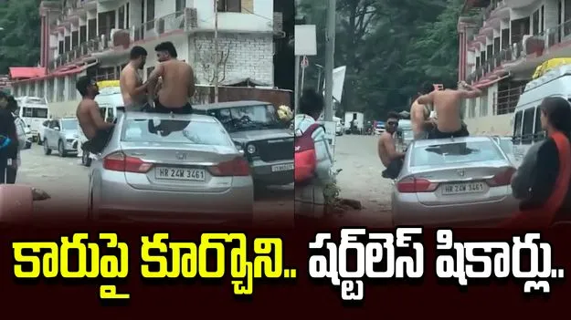 టూరిస్టుల విచిత్ర విన్యాసం.. కారుపై అర్ధనగ్న ప్రయాణం!