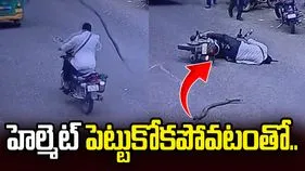 తలపై విరిగిపడ్డ చెట్టు కొమ్మ.. హెల్మెట్ పెట్టుకోకపోవటంతో.. 